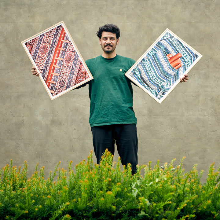 photographer Aso Mohammadi holding his posters for edition 3000
