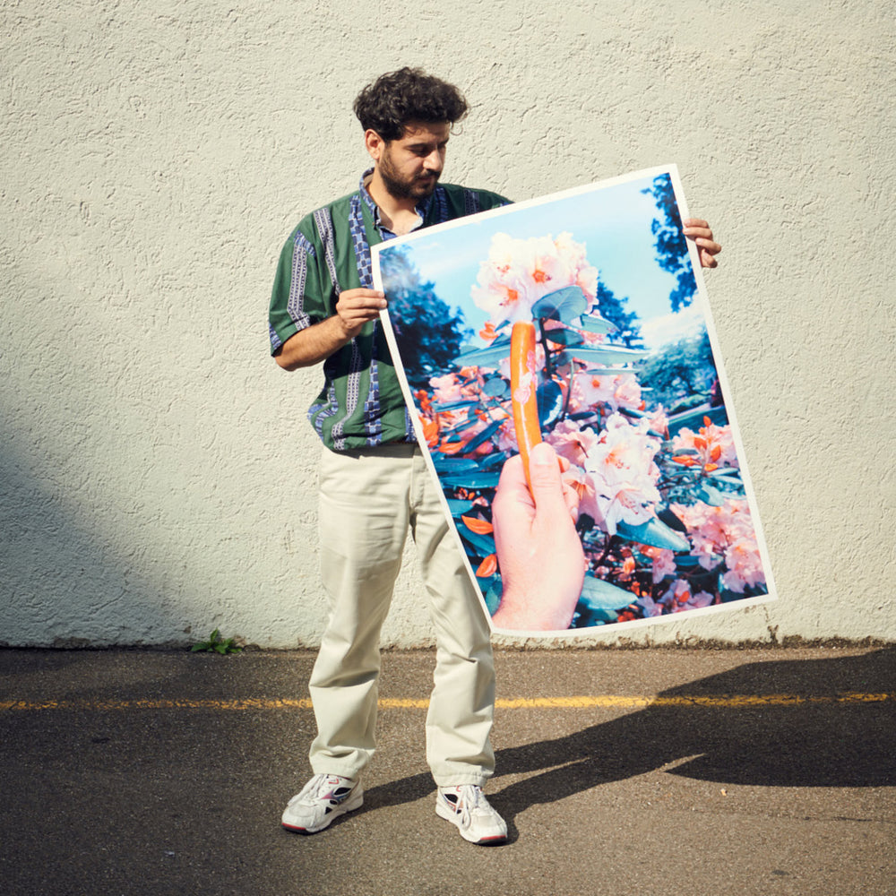 photographer Aso Mohammadi holding his wienerli poster
